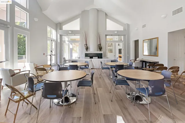 a view of a a dining room with furniture window and wooden floor
