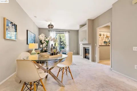 a view of a dining room with furniture and a fireplace