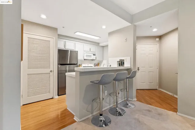 a kitchen with stainless steel appliances a refrigerator a sink a stove a microwave and island