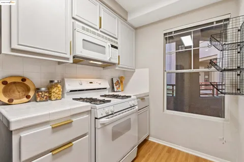 a kitchen with stainless steel appliances granite countertop a stove and a refrigerator