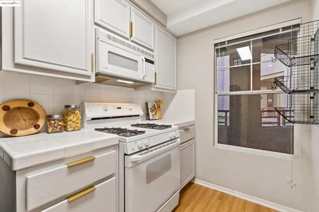 a kitchen with stainless steel appliances granite countertop a stove and a refrigerator