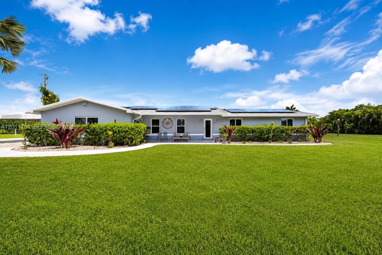 21175 Southwest 232nd Street Miami, FL 33170 - Photo 1 of 66 a front view of a house with a yard