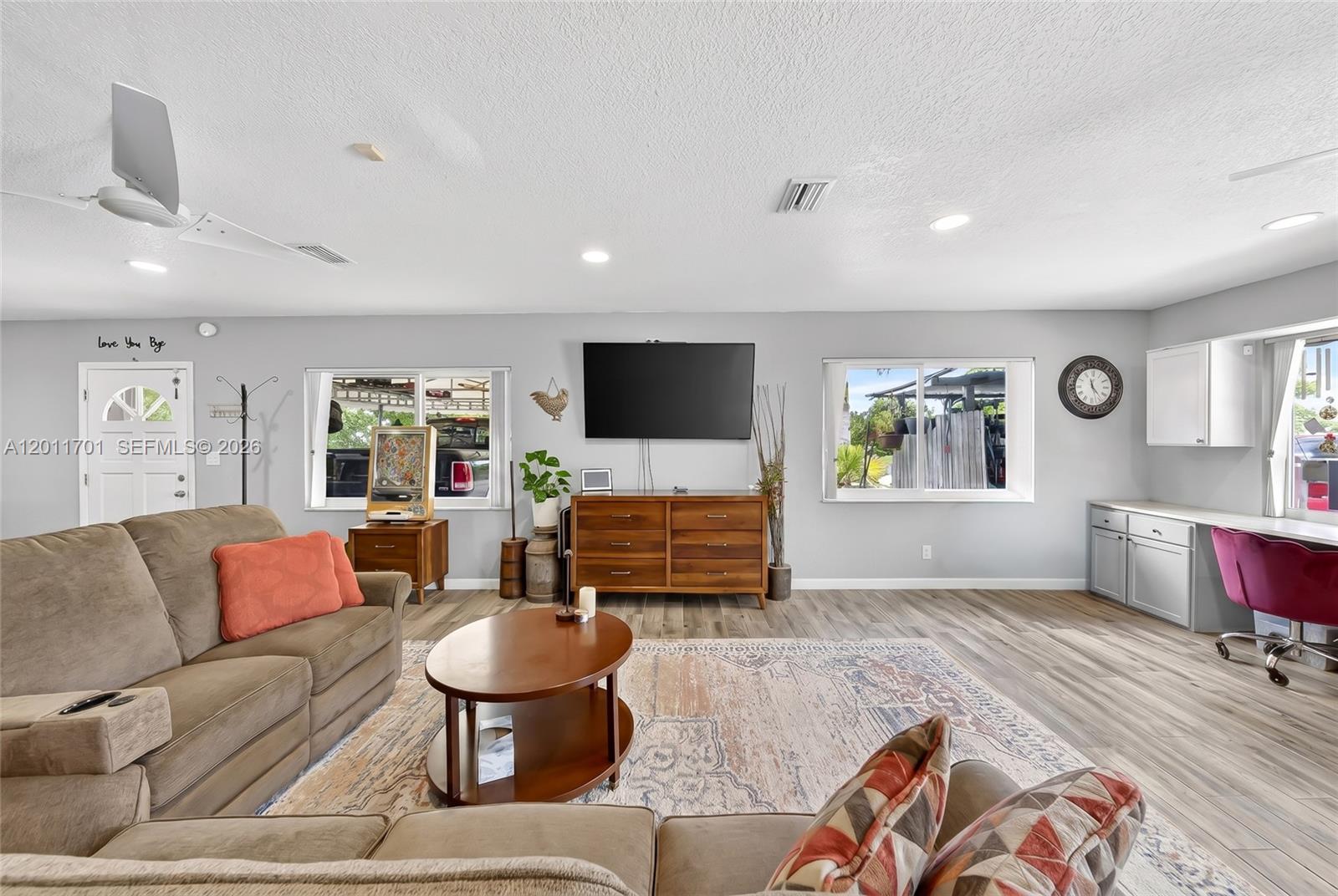 21175 Southwest 232nd Street Miami, FL 33170 - Photo 15 of 66 a living room with furniture and a flat screen tv