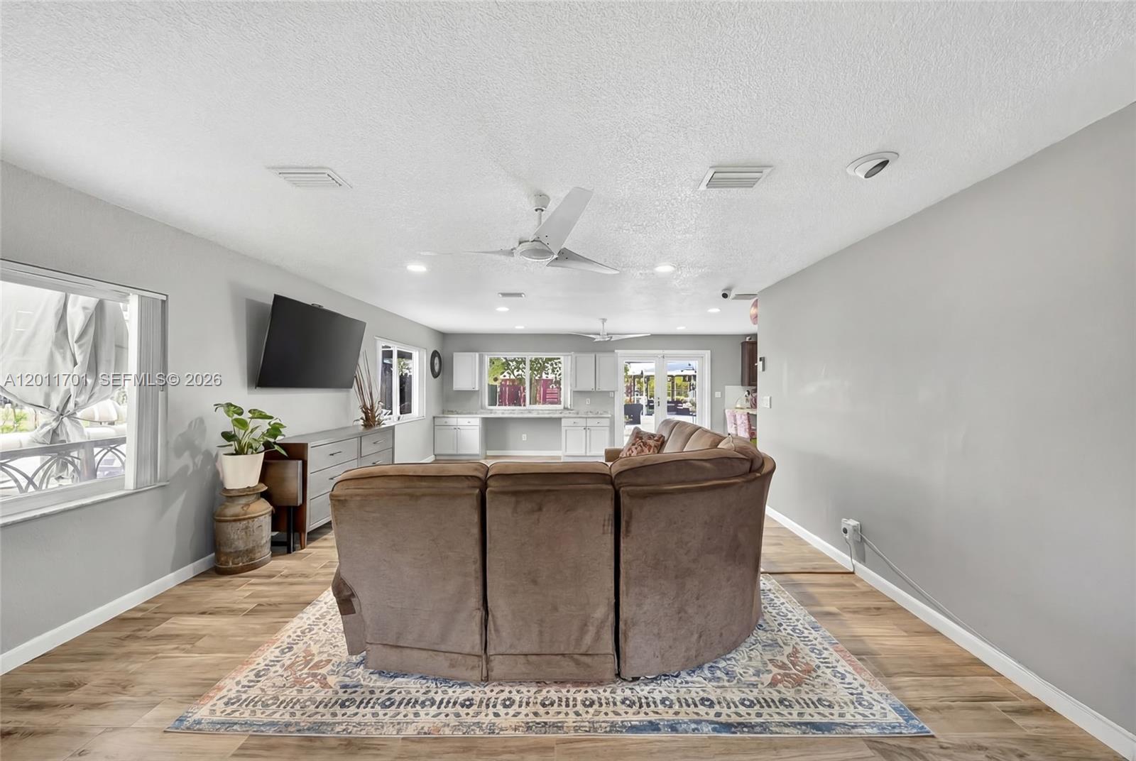 21175 Southwest 232nd Street Miami, FL 33170 - Photo 17 of 66 a living room with furniture and a flat screen tv