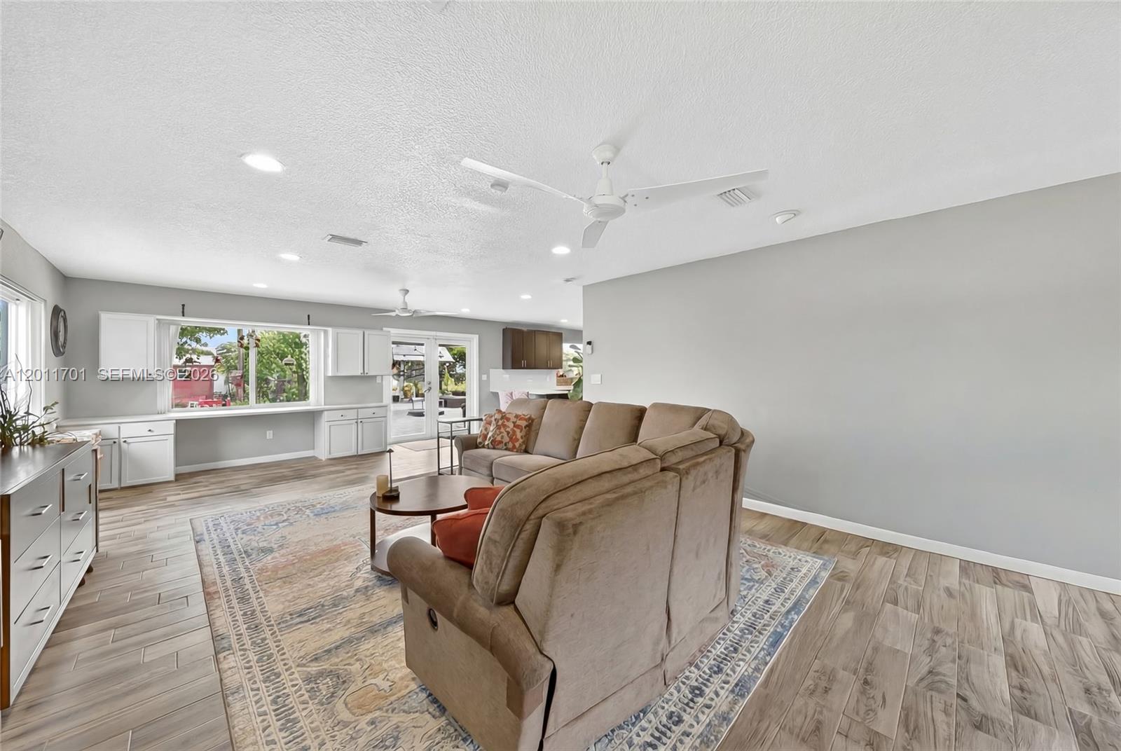 21175 Southwest 232nd Street Miami, FL 33170 - Photo 18 of 66 a living room with furniture and a wooden floor