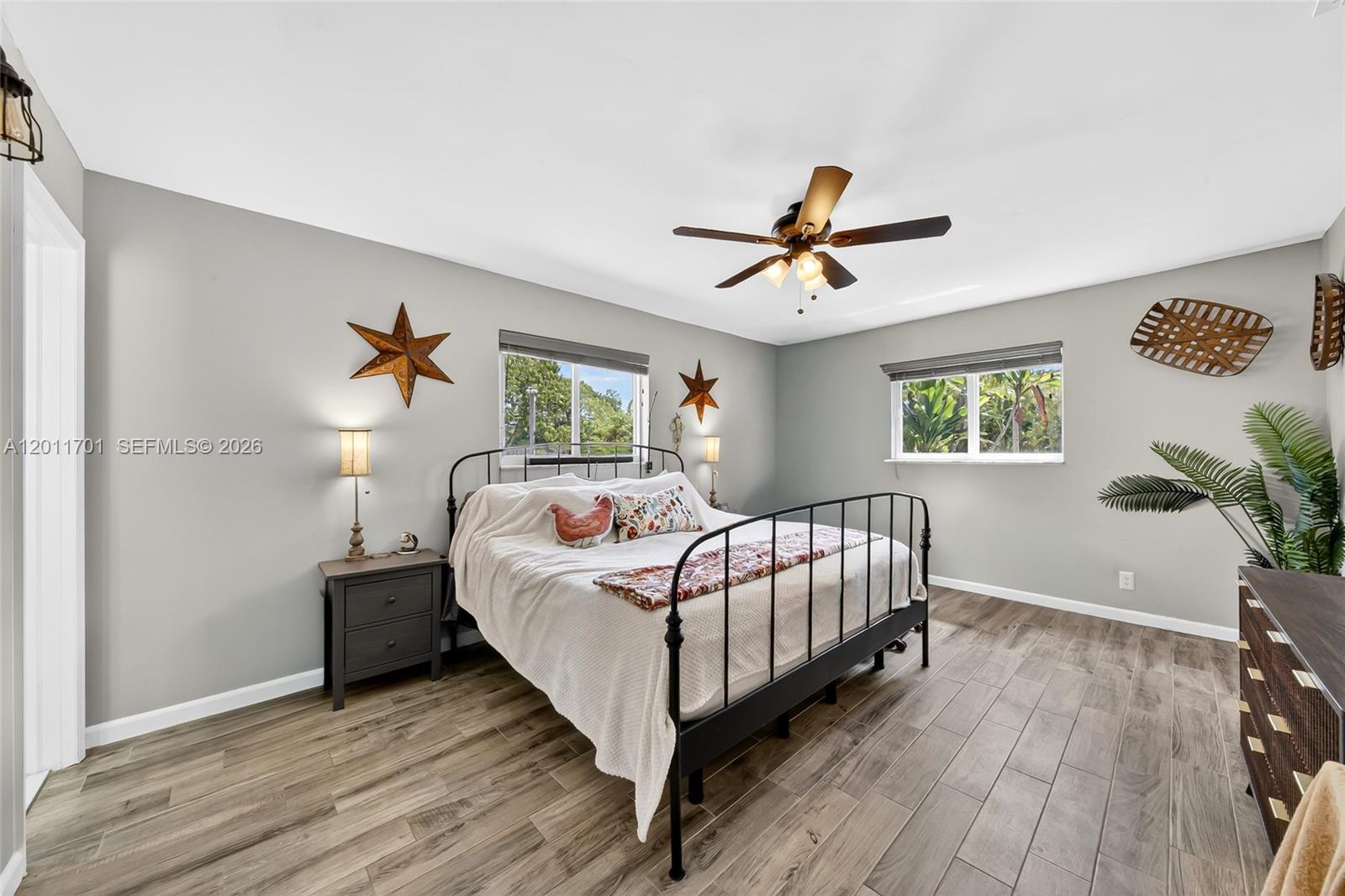 21175 Southwest 232nd Street Miami, FL 33170 - Photo 27 of 66 a bedroom with a bed and a potted plant
