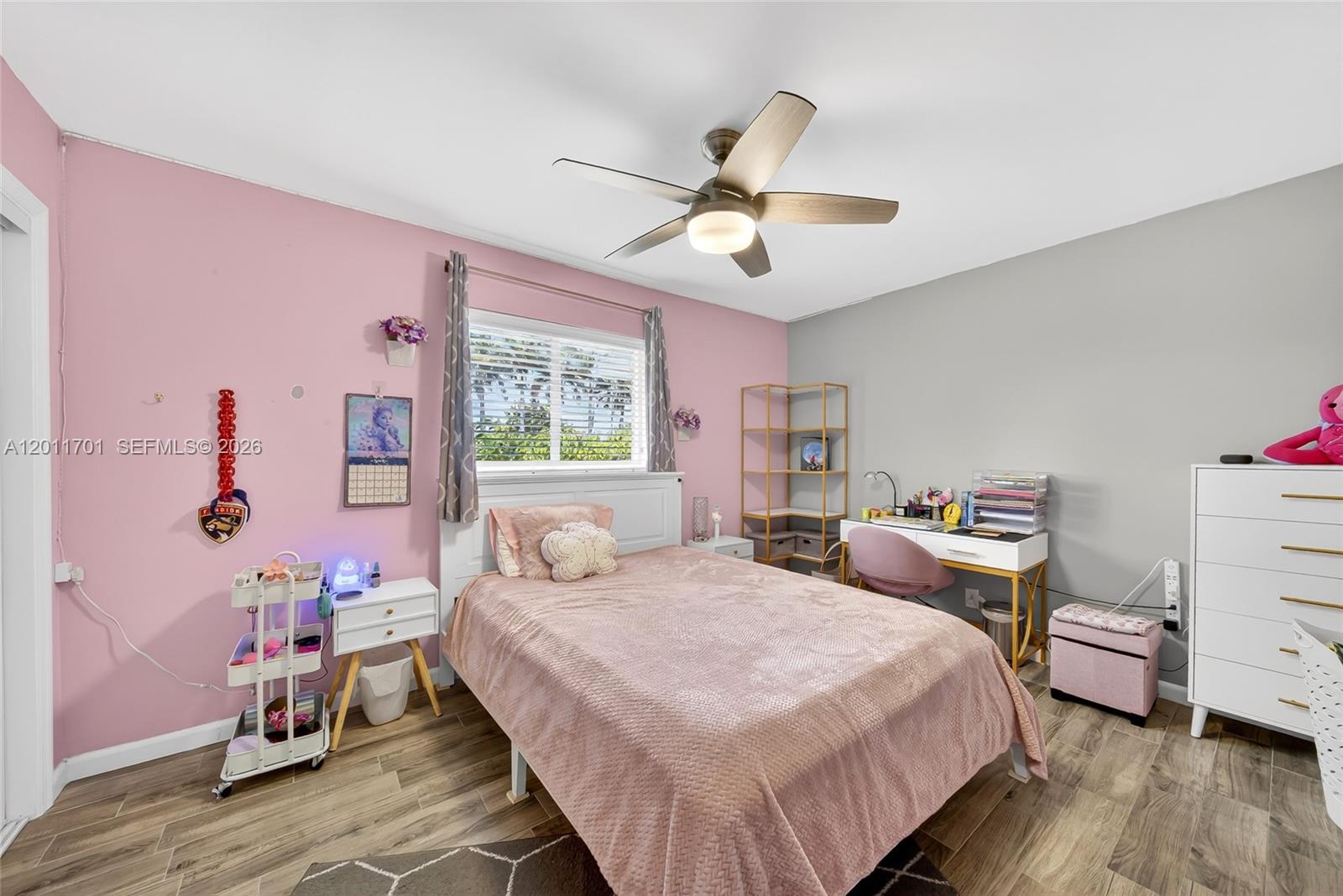 21175 Southwest 232nd Street Miami, FL 33170 - Photo 29 of 66 a bedroom with a bed a chandelier and dresser