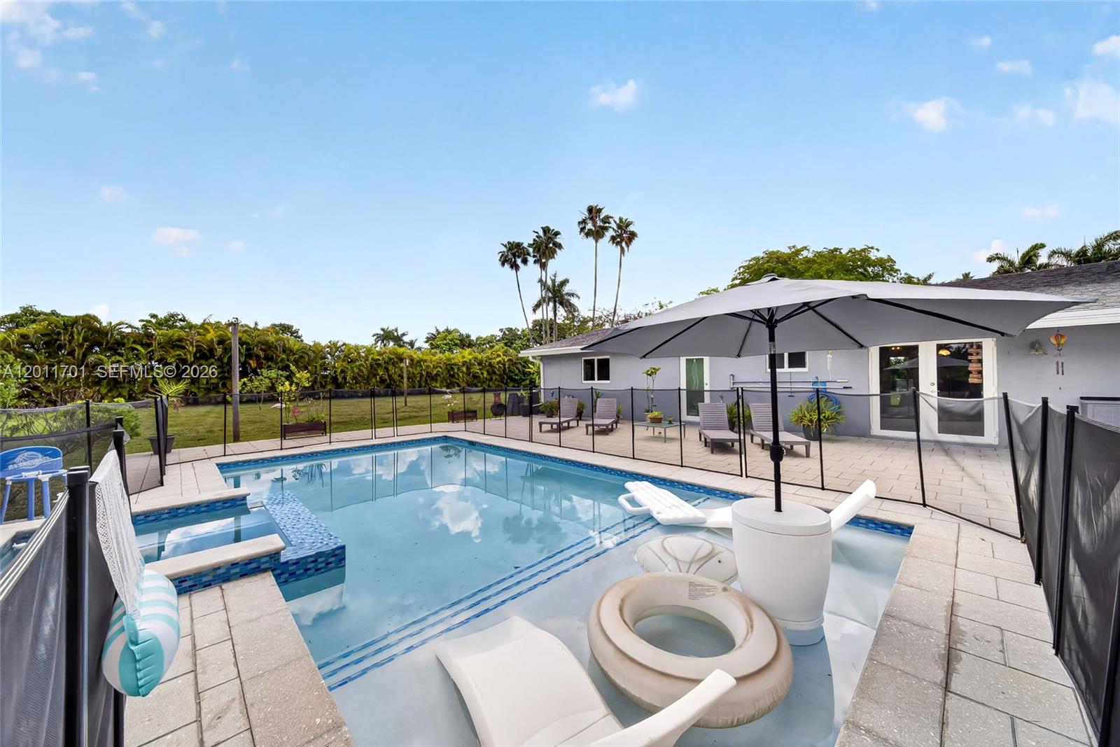 21175 Southwest 232nd Street Miami, FL 33170 - Photo 31 of 66 a view of a house with swimming pool and sitting area