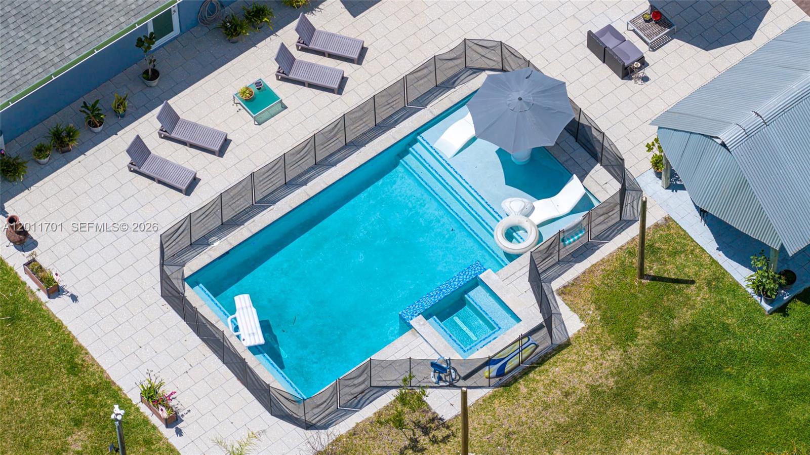 21175 Southwest 232nd Street Miami, FL 33170 - Photo 36 of 66 an aerial view of a house with a swimming pool