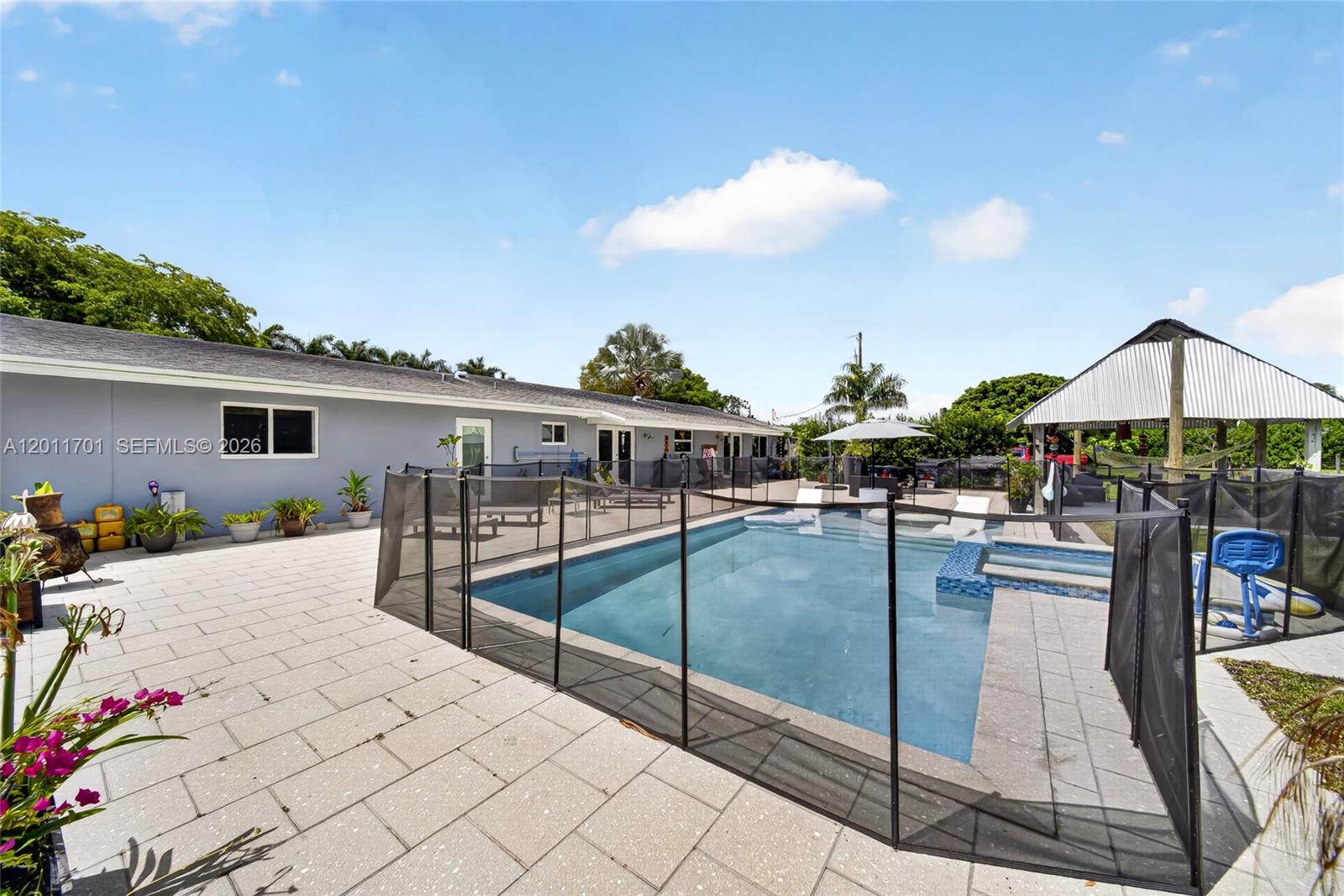 21175 Southwest 232nd Street Miami, FL 33170 - Photo 40 of 66 a view of a swimming pool with a lounge chairs