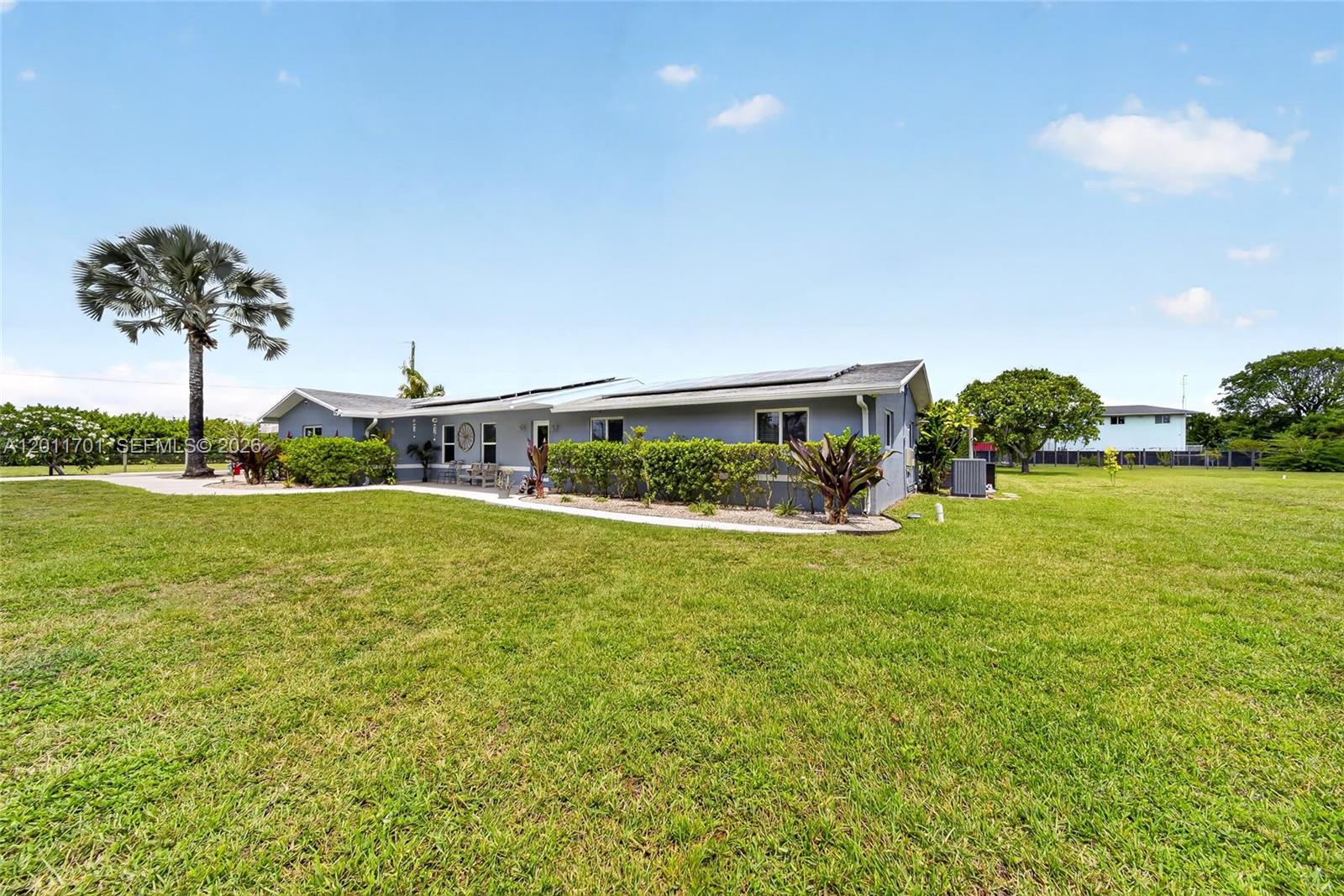 21175 Southwest 232nd Street Miami, FL 33170 - Photo 4 of 66 a view of a house with a big yard and potted plants