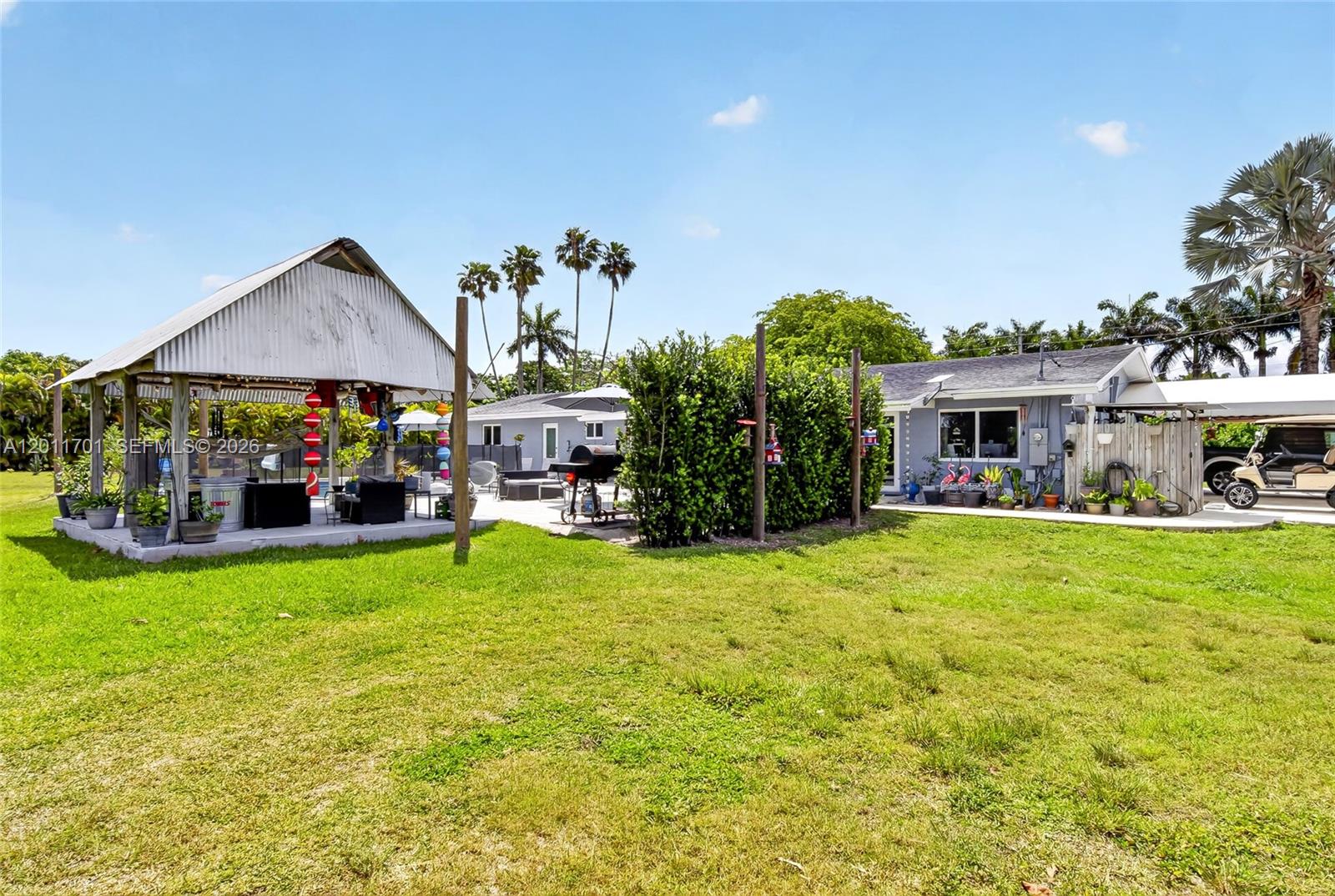 21175 Southwest 232nd Street Miami, FL 33170 - Photo 45 of 66 a view of house with a garden and swimming pool