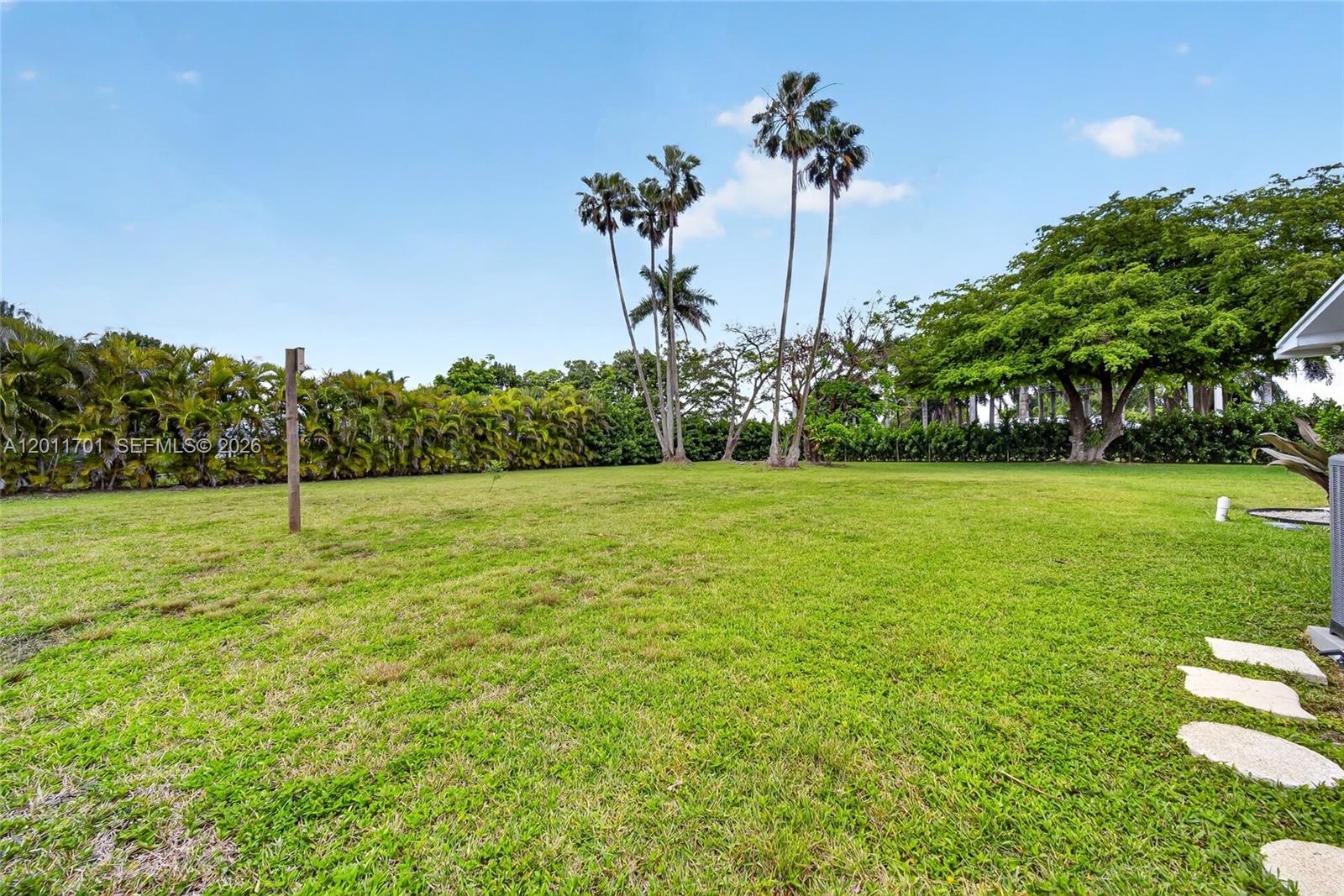 21175 Southwest 232nd Street Miami, FL 33170 - Photo 50 of 66 a view of a garden with a building in the background