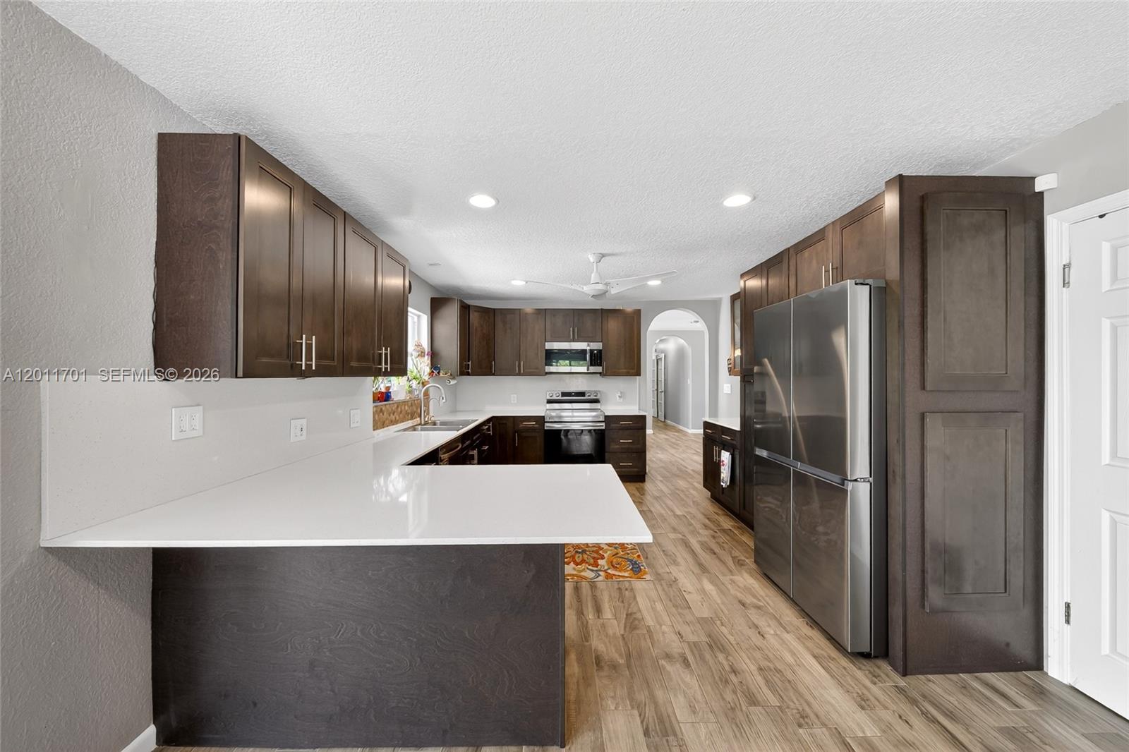 21175 Southwest 232nd Street Miami, FL 33170 - Photo 6 of 66 a kitchen with stainless steel appliances a refrigerator and a stove top oven