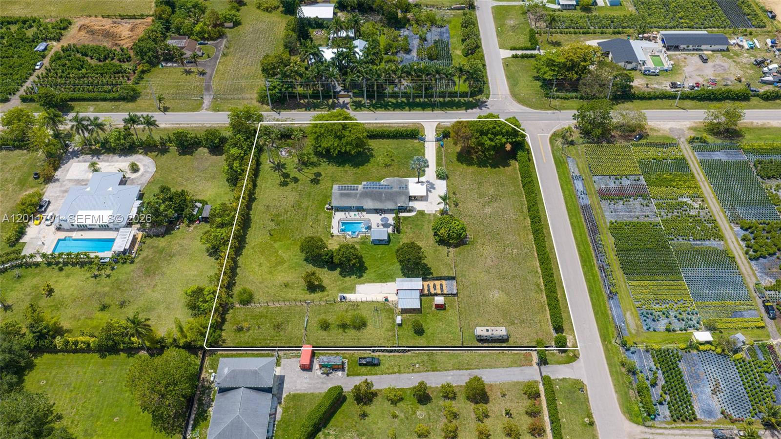 21175 Southwest 232nd Street Miami, FL 33170 - Photo 61 of 66 an aerial view of residential houses with outdoor space and swimming pool