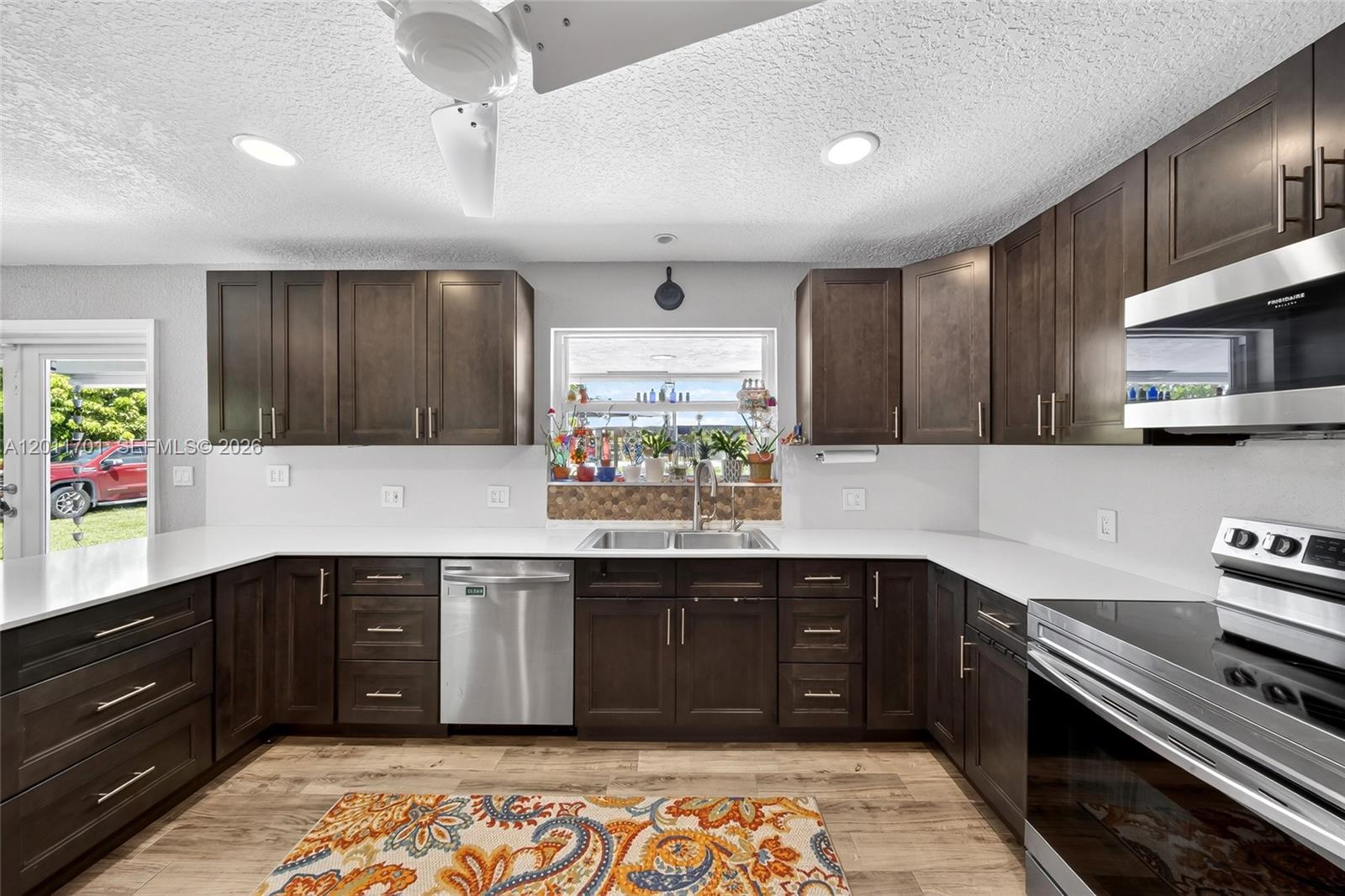 21175 Southwest 232nd Street Miami, FL 33170 - Photo 8 of 66 a kitchen with a sink and cabinets