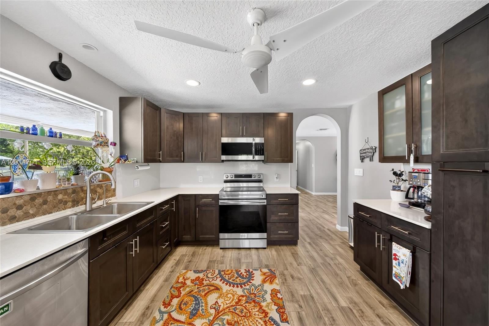 21175 Southwest 232nd Street Miami, FL 33170 - Photo 9 of 66 a kitchen with stainless steel appliances granite countertop a sink a stove and a wooden floors