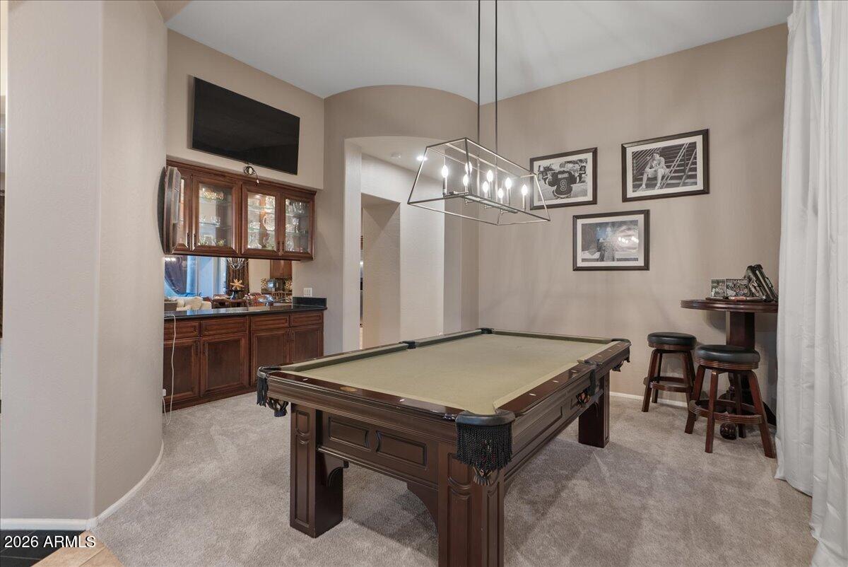 6427 South Magic Court Gilbert, AZ 85298 - Photo 7 of 71 a living room with a table chairs and a refrigerator