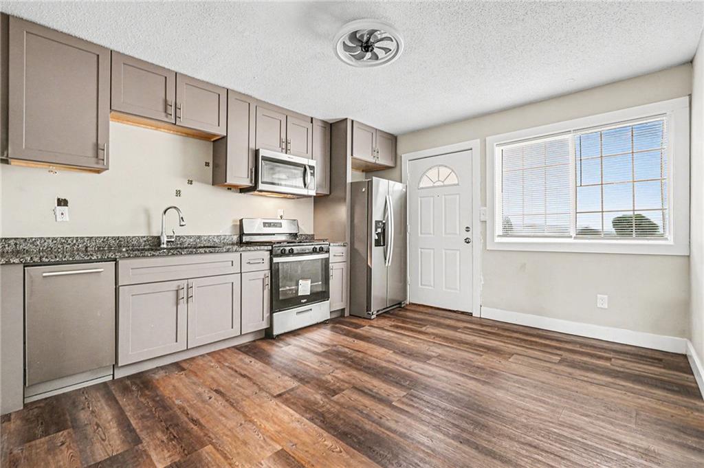 405 Fairburn Road Southwest, Unit 231 Atlanta, GA 30331 - Photo 7 of 16 a kitchen with stainless steel appliances granite countertop a refrigerator sink and cabinets