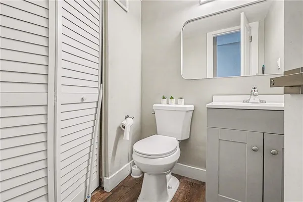 a bathroom with a toilet a sink and mirror