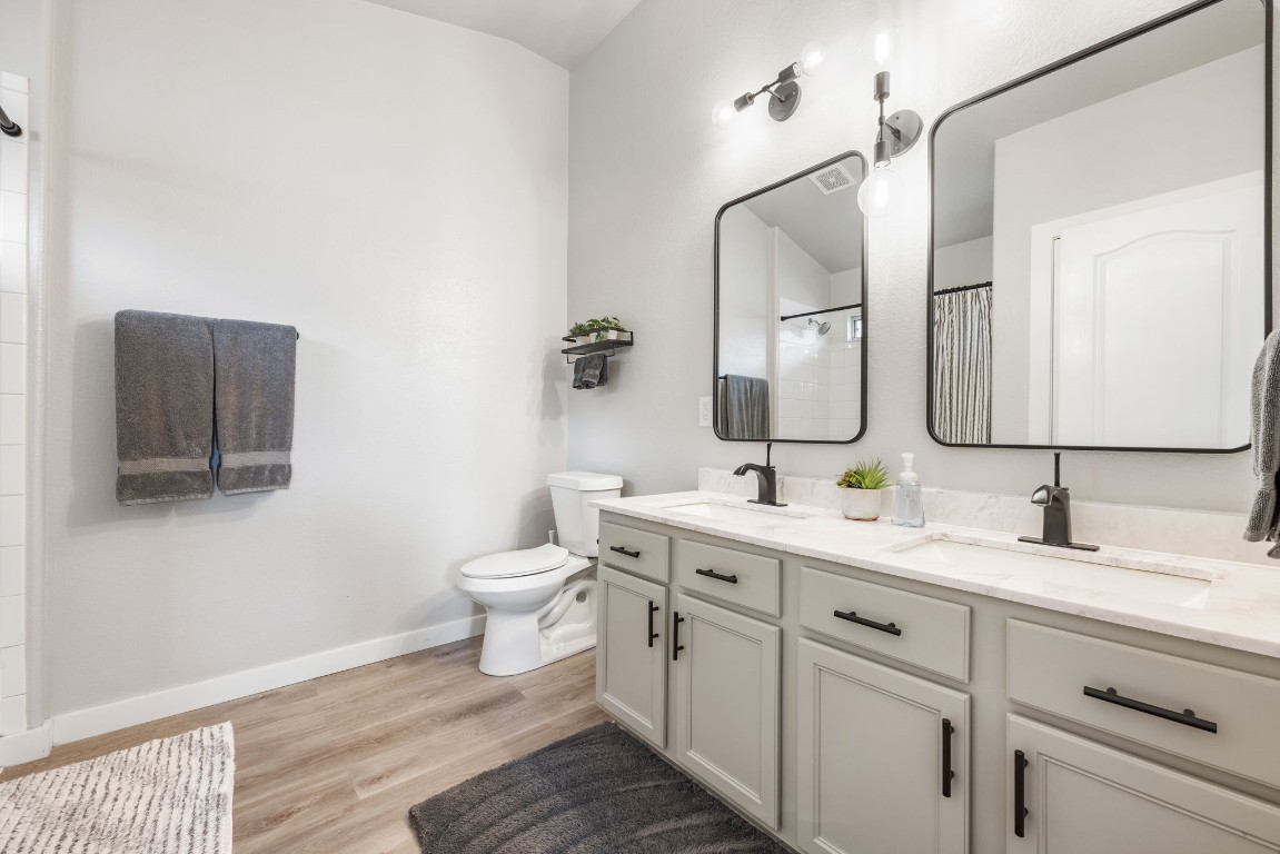 3309 Wickham Lane Austin, TX 78725 - Photo 12 of 24 a bathroom with a toilet sink and mirror