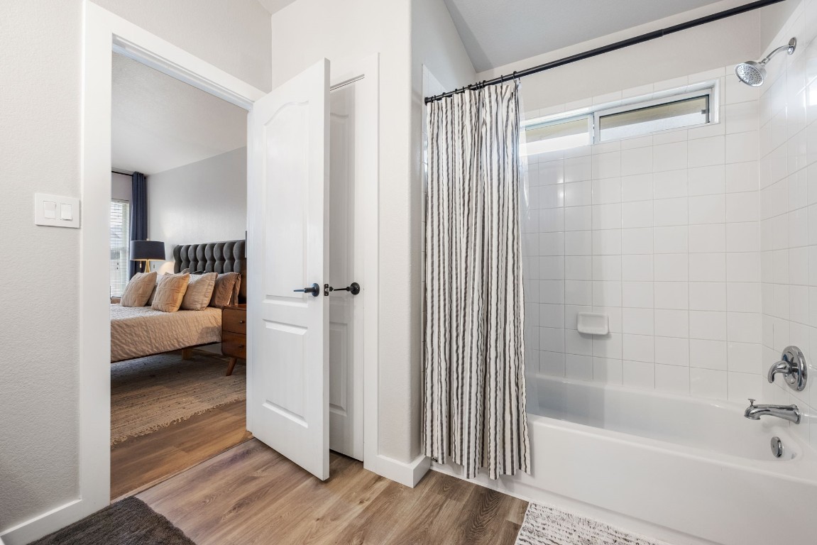 3309 Wickham Lane Austin, TX 78725 - Photo 13 of 24 a bathroom with a tub shower view and a bathroom