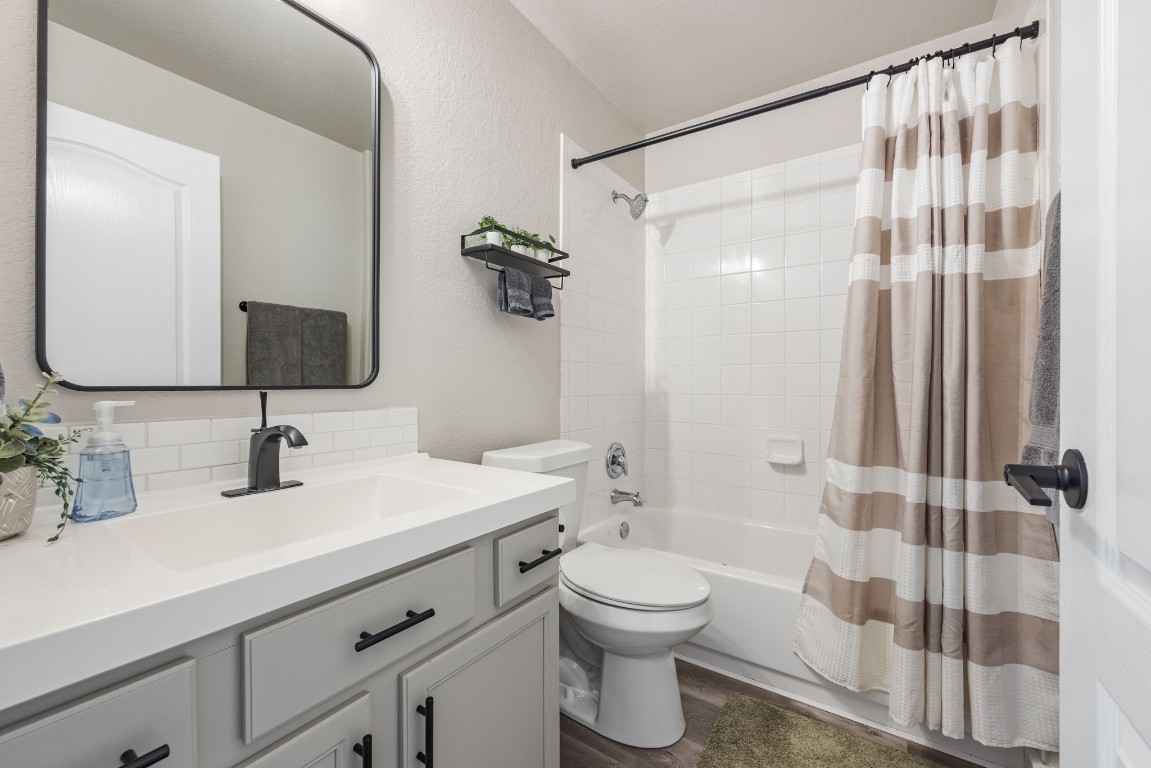 3309 Wickham Lane Austin, TX 78725 - Photo 16 of 24 a bathroom with a sink a toilet and shower