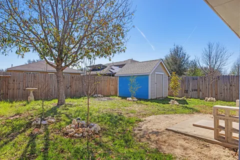 a backyard of a house with table and chairs