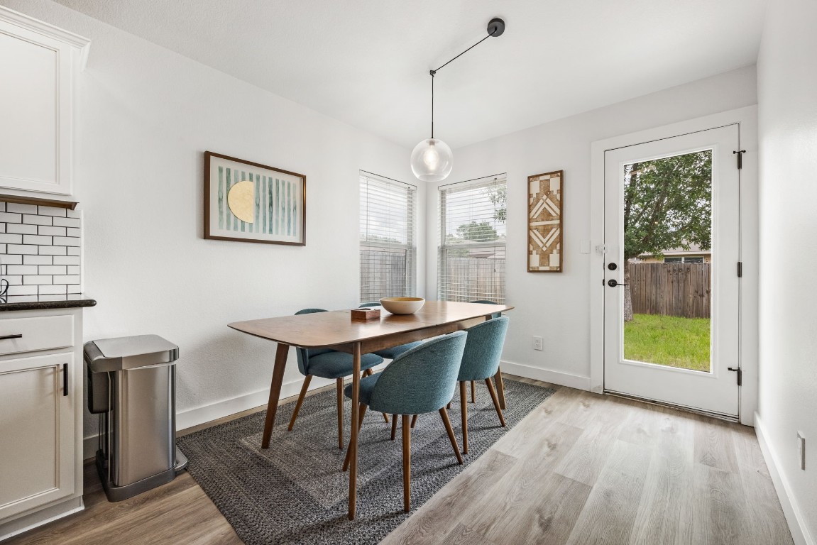 3309 Wickham Lane Austin, TX 78725 - Photo 9 of 24 a view of a dining room with furniture window and wooden floor