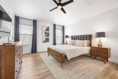 a spacious bedroom with a bed and a window