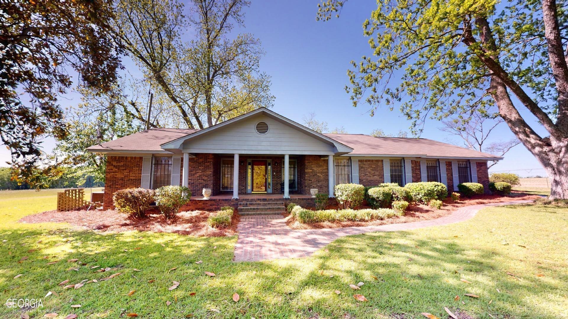 a front view of a house with yard outdoor seating and barbeque oven