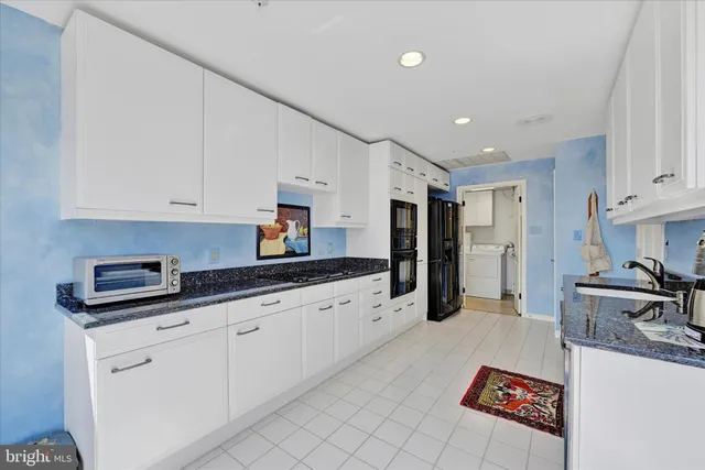 a kitchen with granite countertop a sink and cabinets