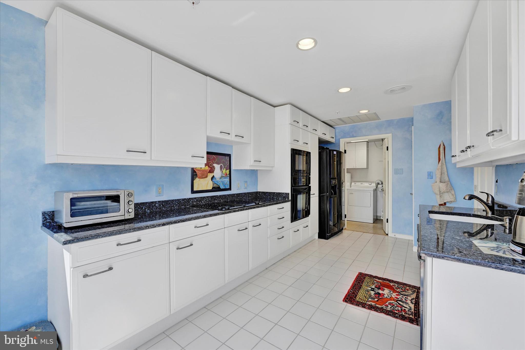 3801 Canterbury Road, Unit 1002 Baltimore, MD 21218 - Photo 12 of 32 a kitchen with granite countertop a sink and cabinets