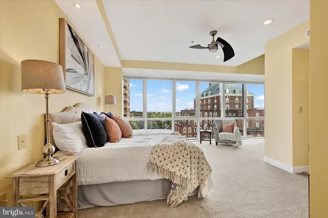 a living room with a bed furniture and a large window