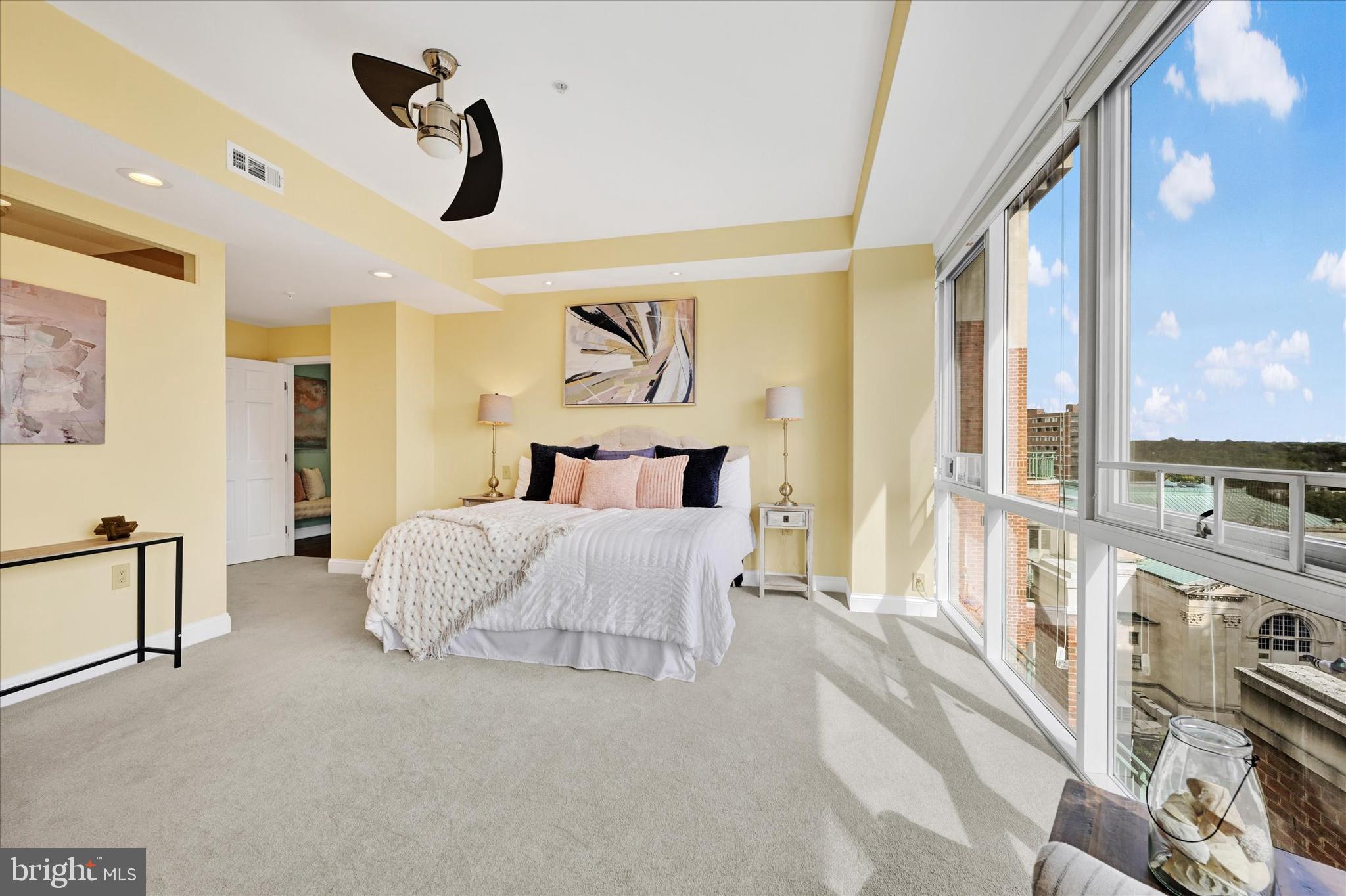 3801 Canterbury Road, Unit 1002 Baltimore, MD 21218 - Photo 19 of 32 a bedroom with a bed next to a large window with the outer view