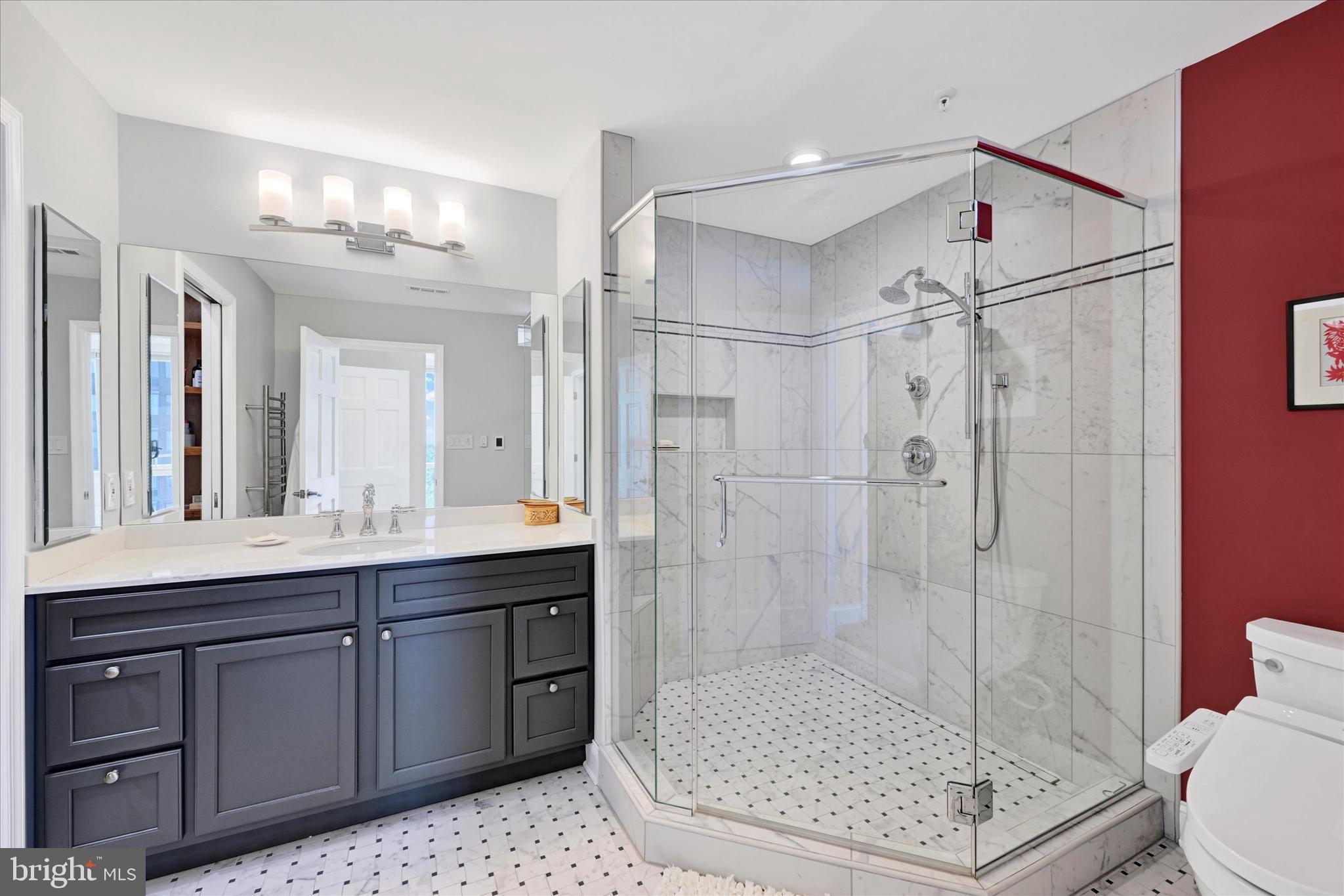 3801 Canterbury Road, Unit 1002 Baltimore, MD 21218 - Photo 22 of 32 a bathroom with a shower sink and mirror