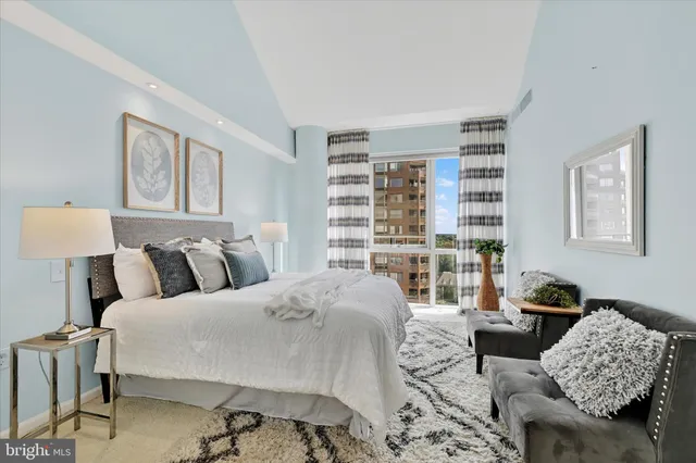 a living room with a couch and a book shelf