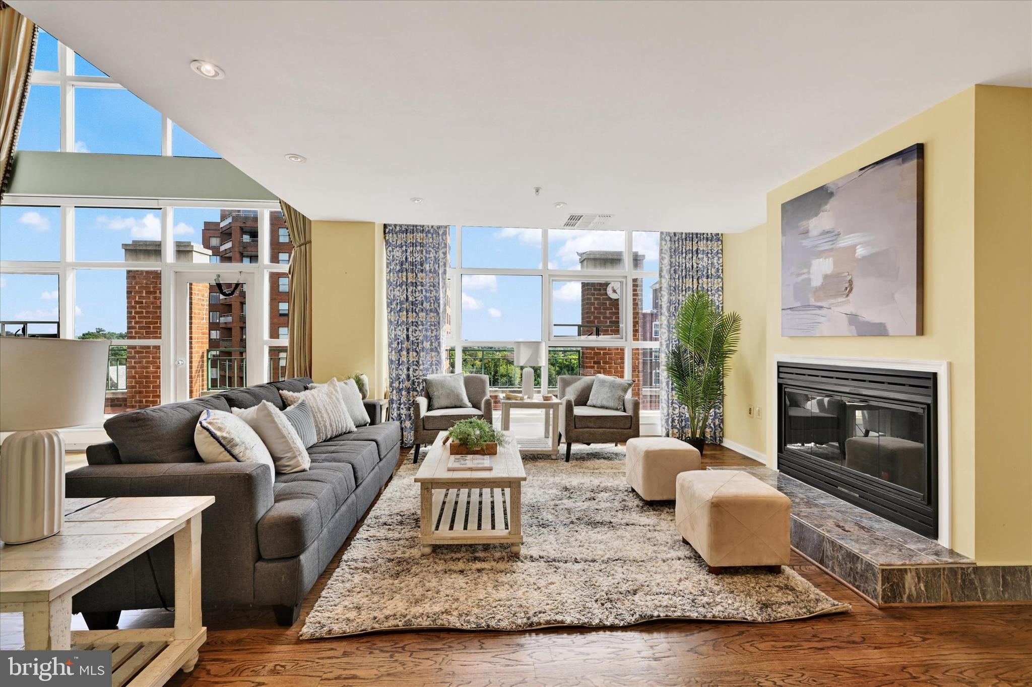 3801 Canterbury Road, Unit 1002 Baltimore, MD 21218 - Photo 6 of 32 a living room with furniture and a fireplace