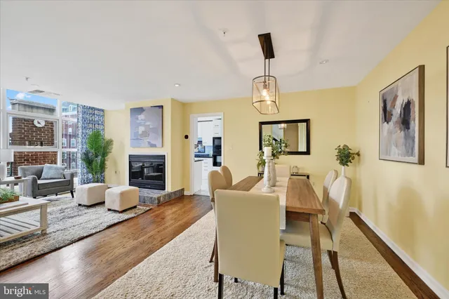 a view of a dining room with furniture a chandelier and wooden floor