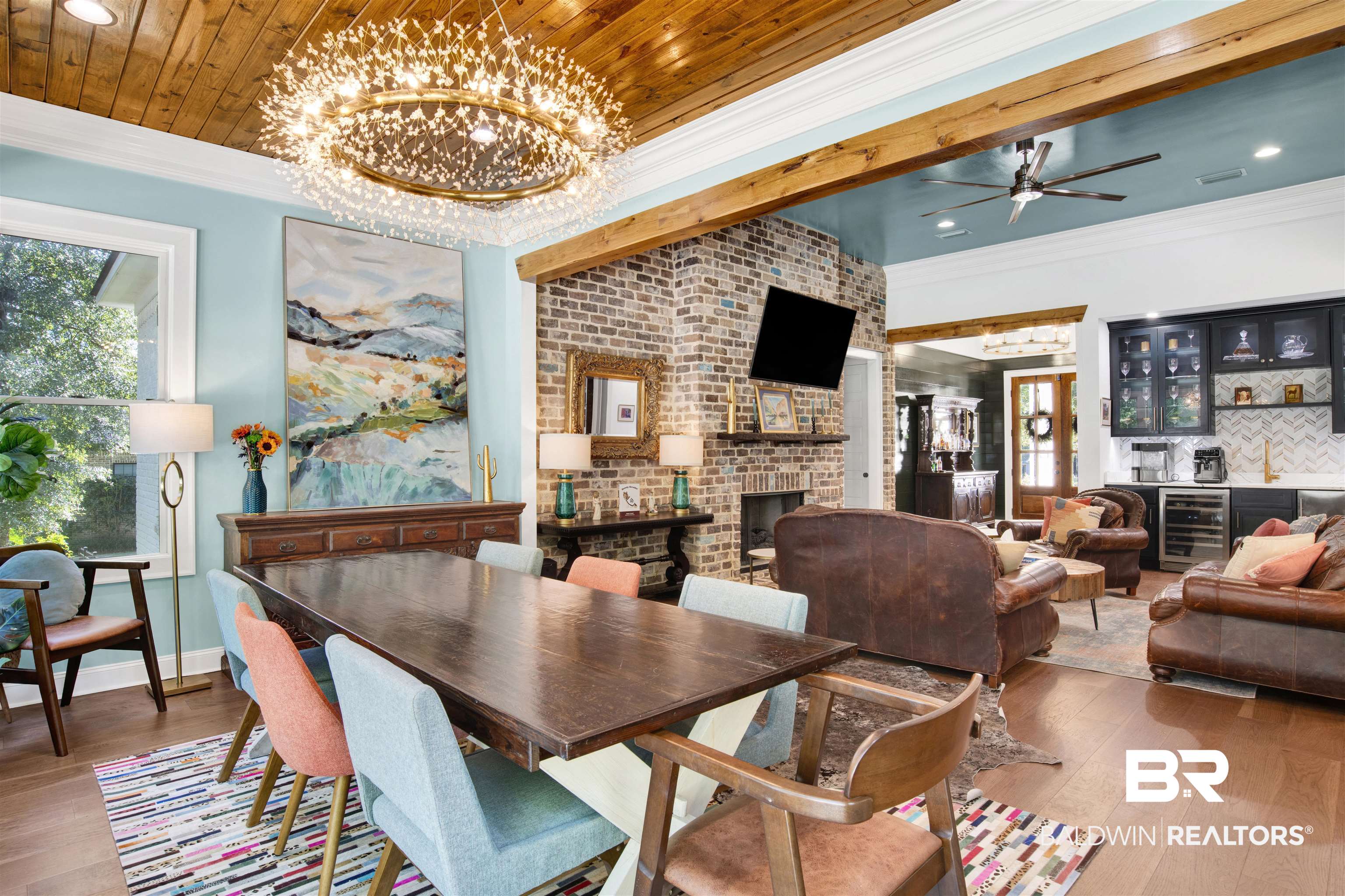 11116 Redfern Road Daphne, AL 36526 - Photo 17 of 46 Dining space featuring a chandelier, wood finished floors, crown molding, a bar, and beverage cooler