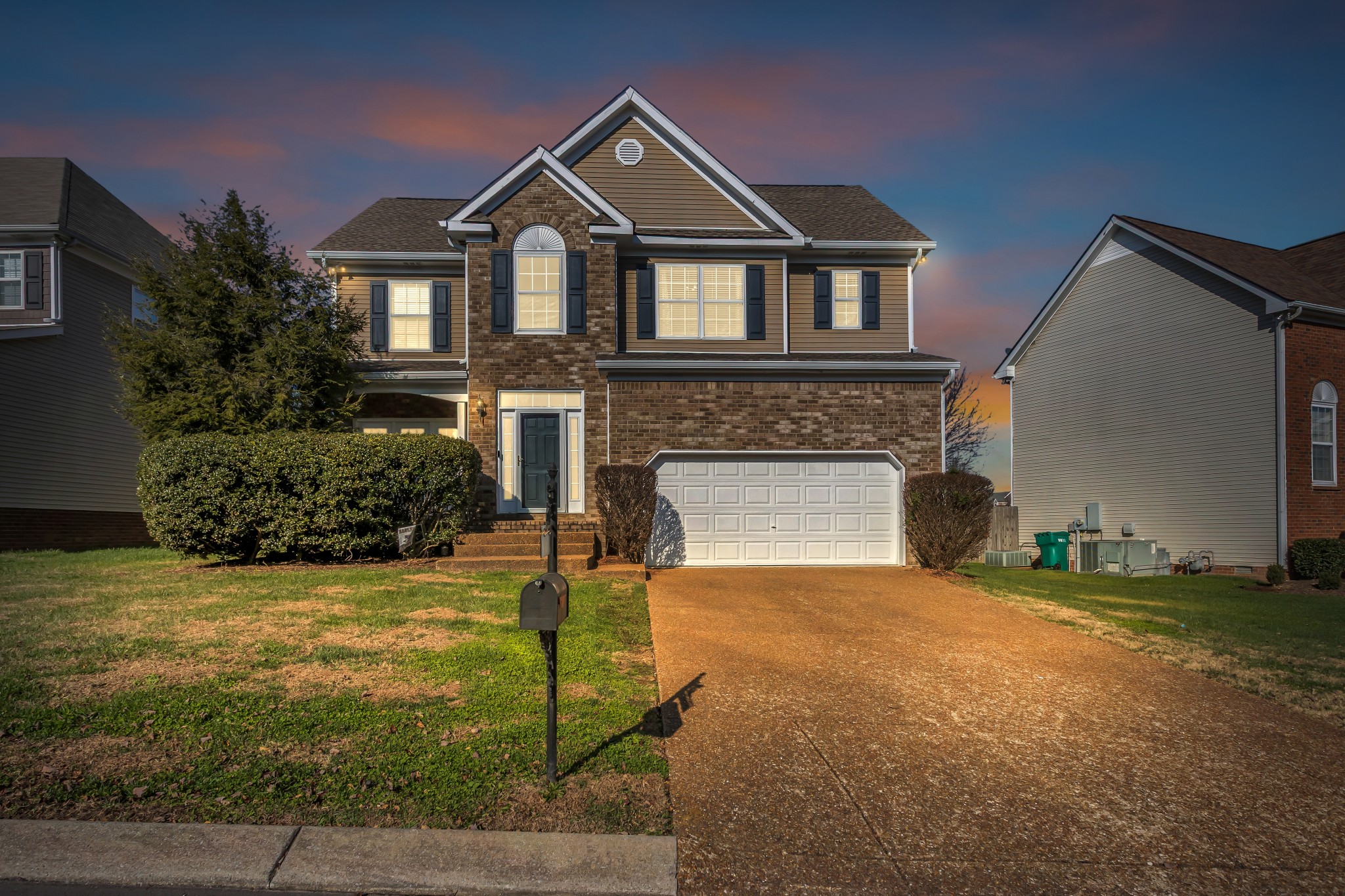 7009 Masonboro Drive Spring Hill, TN 37174 - Photo 1 of 40 a front view of a house with yard and trees