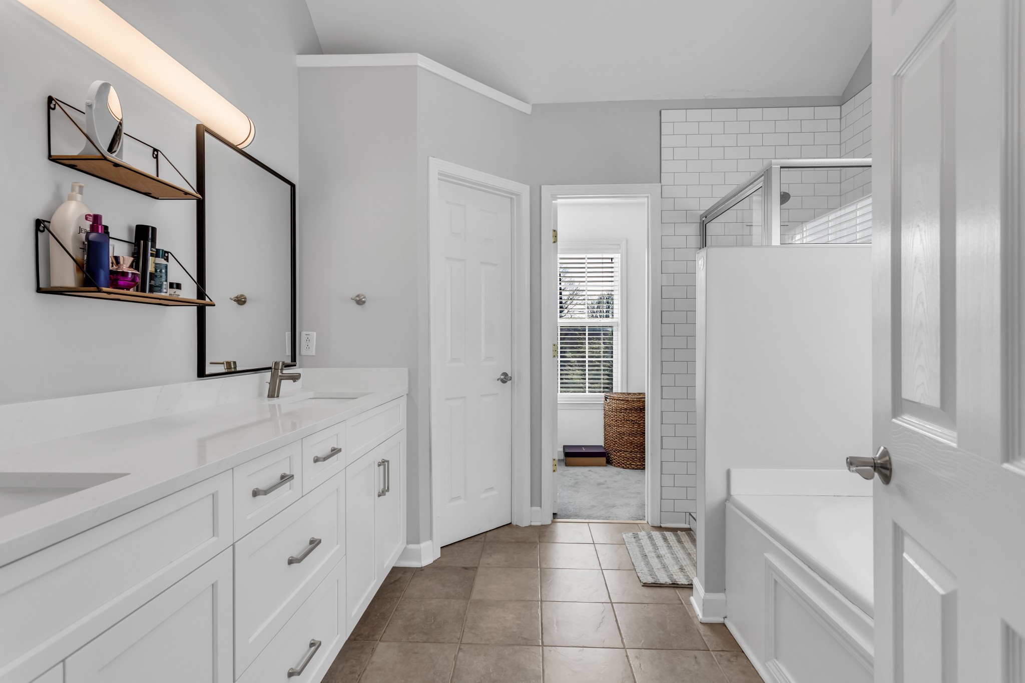 7009 Masonboro Drive Spring Hill, TN 37174 - Photo 23 of 40 a spacious bathroom with a tub sink and mirror