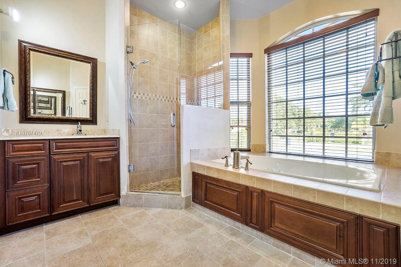 6915 Southwest 185th Way Southwest Ranches, FL 33332 - Photo 13 of 48 a spacious bathroom with a tub sink and mirror