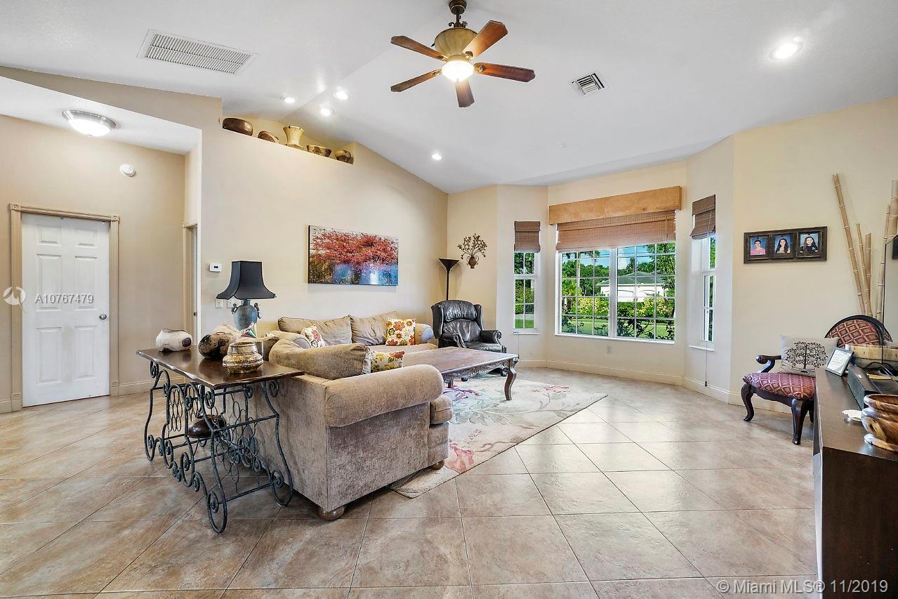 6915 Southwest 185th Way Southwest Ranches, FL 33332 - Photo 23 of 48 a living room with furniture and a large window