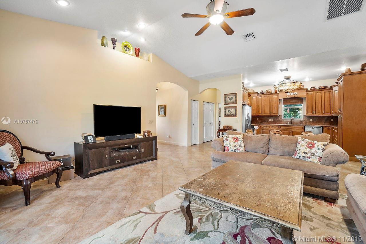 6915 Southwest 185th Way Southwest Ranches, FL 33332 - Photo 26 of 48 a living room with furniture and a flat screen tv