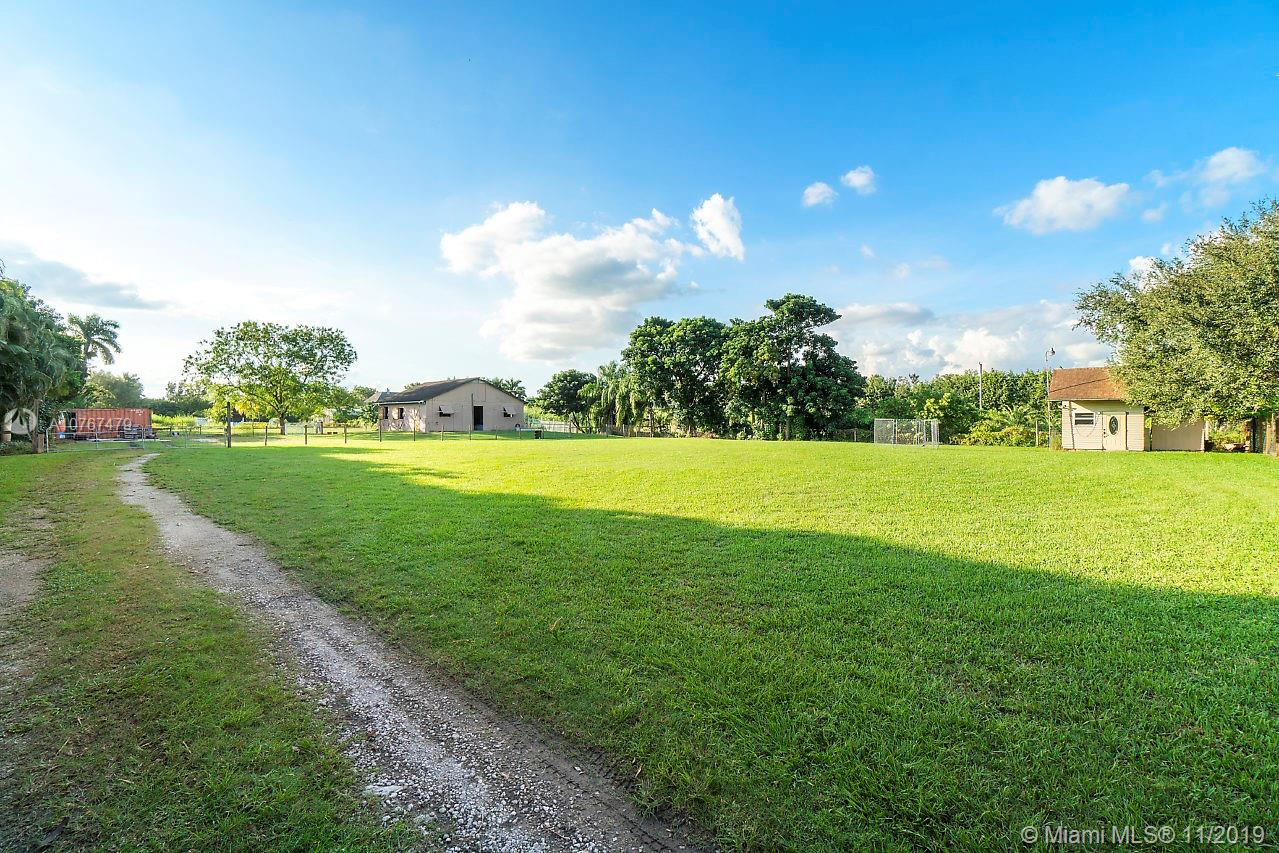 6915 Southwest 185th Way Southwest Ranches, FL 33332 - Photo 41 of 48 a view of a golf course with a lake