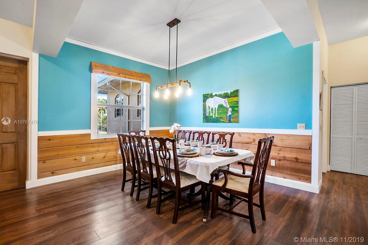 6915 Southwest 185th Way Southwest Ranches, FL 33332 - Photo 5 of 48 a view of a dining room with furniture window and wooden floor