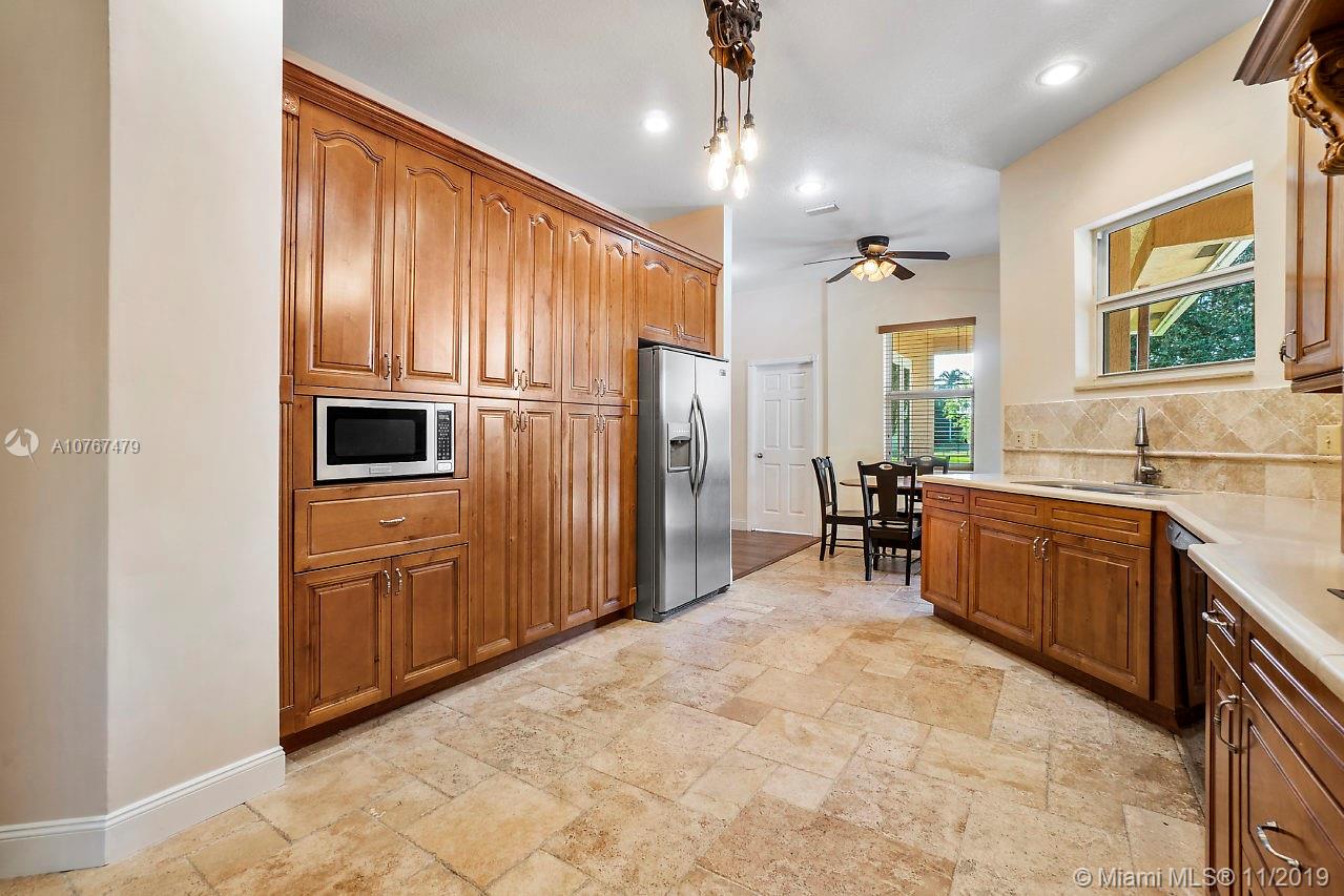6915 Southwest 185th Way Southwest Ranches, FL 33332 - Photo 8 of 48 a kitchen with sink cabinets and window