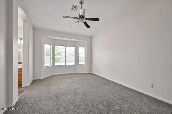 a view of room with a ceiling fan