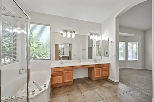 a large bathroom with a large tub and sink